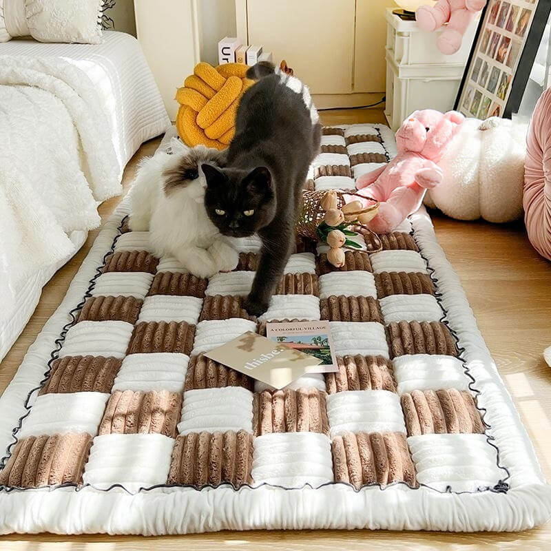 Chenille pet blanket with brown and white striped tiles and scalloped border