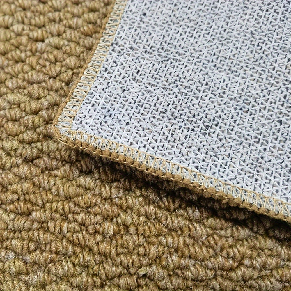 Close-up of doormat corner showing beige pile and white gridded underside.