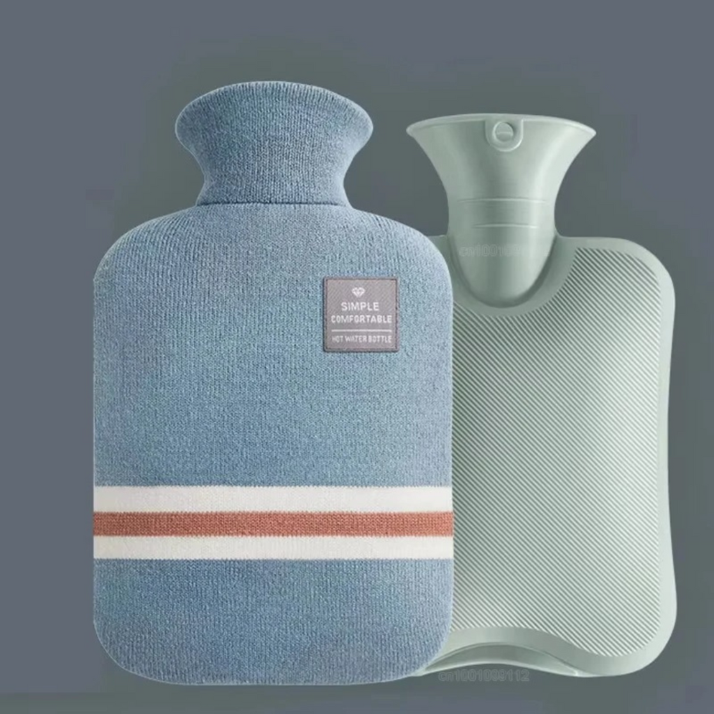 Blue knit hot water bottle cover beside white hot water bottle