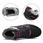 Unisex winter boots in black with faux fur lining, padded strap, and tread outsole