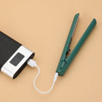 Mini 2-in-1 travel curling and straightening iron in dark teal, with power cord.