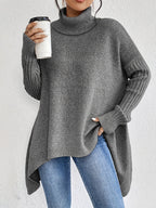 Grey women’s loose turtleneck sweater with long sleeves and asymmetrical high-low hem