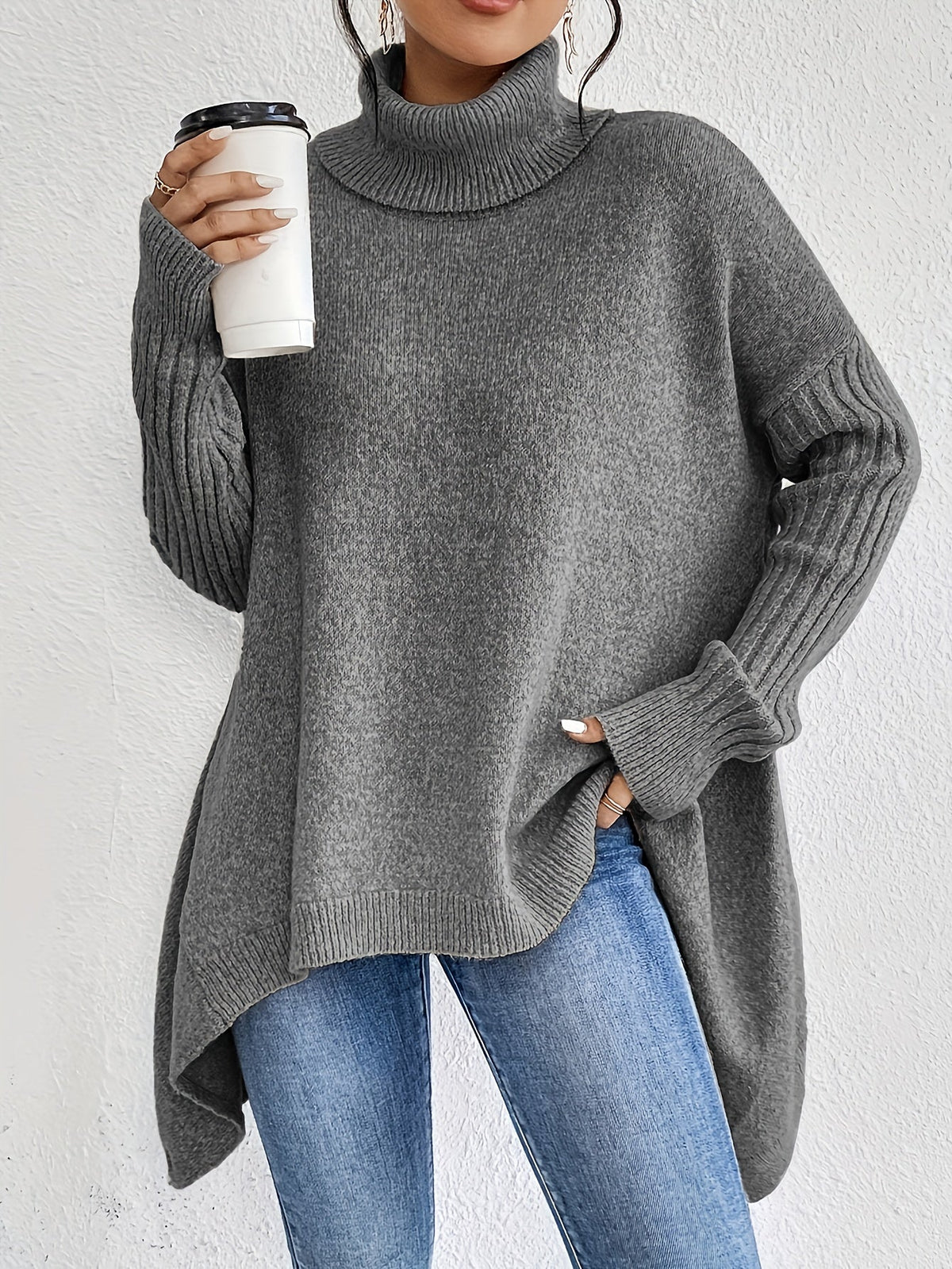 Grey women’s loose turtleneck sweater with long sleeves and asymmetrical high-low hem
