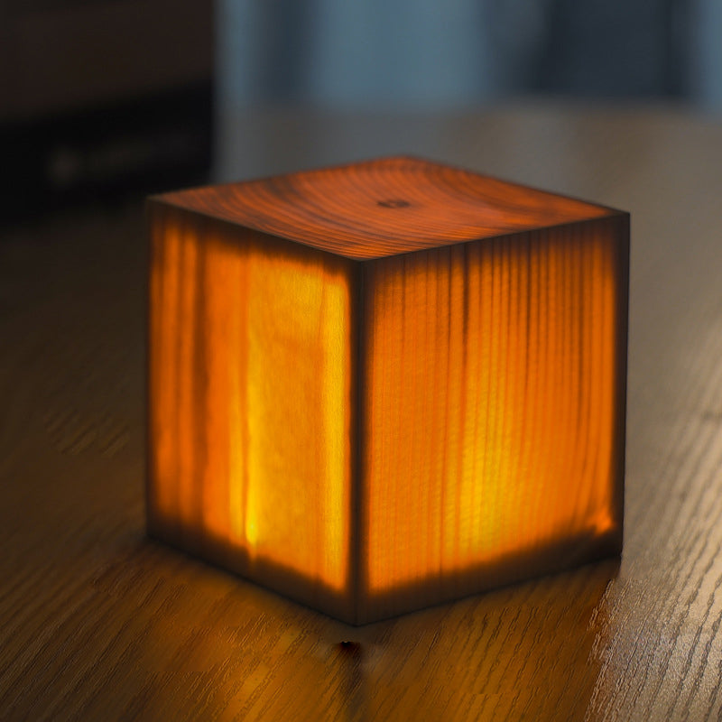 Wood-look square LED night light cube with warm glow and dark base