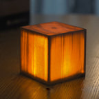 Wood-look square LED night light cube with warm glow and dark base