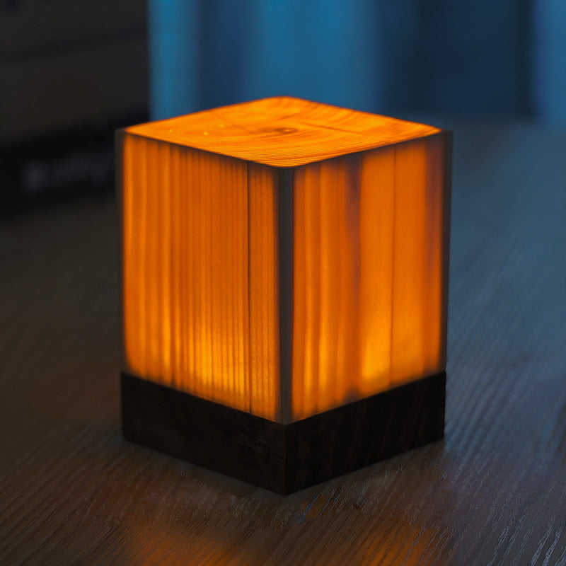 Wood-look square LED night light cube with warm glow and dark base