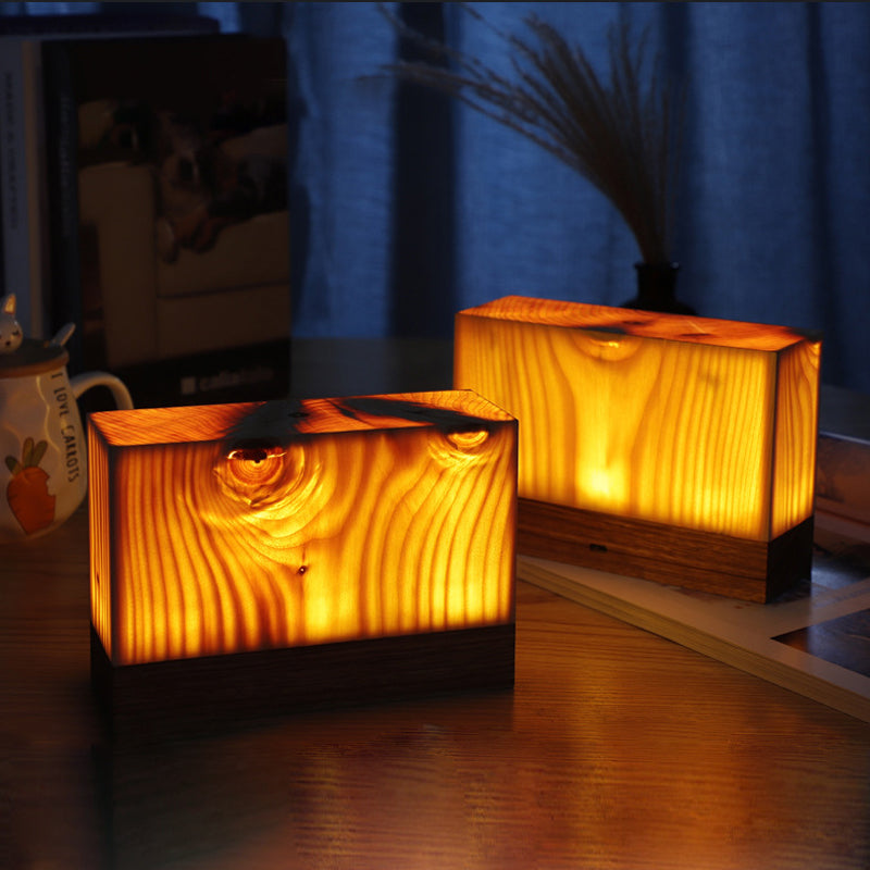Rectangular and cube wood-look LED night lights with warm glow on a tabletop