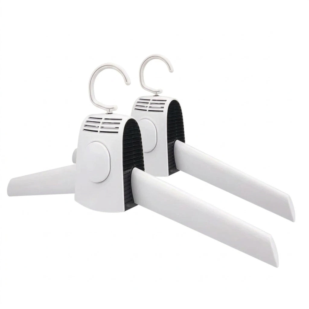 White hangers with black straps on a white surface