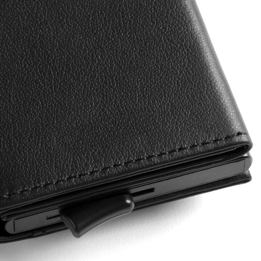 Close-up of black leather wallet edge with stitched seam and smooth inner panel