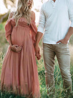 Pink off-shoulder maternity dress with smocked bodice and flowing full skirt