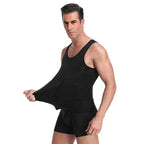 Men's compression tank undershirt, black sleeveless; model posing in profile