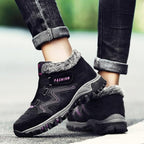 Unisex winter boots in black with faux fur lining, purple accents, and chunky tread sole
