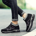 Black winter boots with faux fur collar and hook-and-loop straps, non-slip tread sole