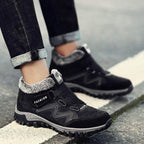 Black winter boots close-up with faux fur lining, hook-and-loop straps, grippy sole