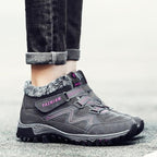 Gray winter boots with faux fur lining and strap closure, thick lug tread sole