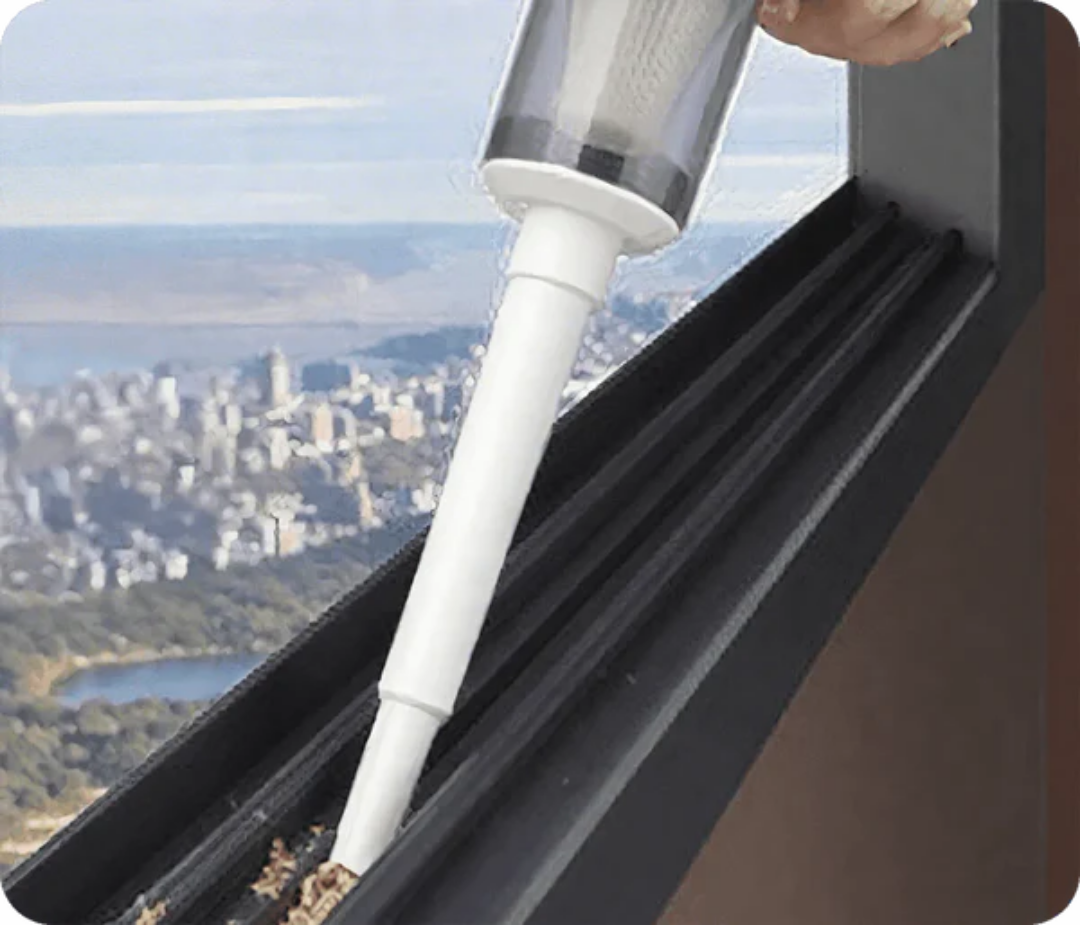 Vacuum mop head and white extension tube cleaning along a dark floor edge