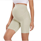 Cream maternity bike-length leggings with high waist and stitched seam paneling