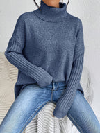 Women’s loose turtleneck sweater, dark blue knit with ribbed cuffs and hem.