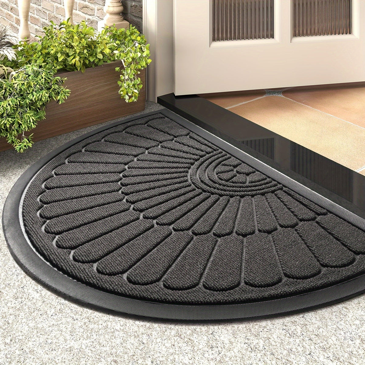 Black half-round outdoor rubber door mat with raised traction pattern and ridged border