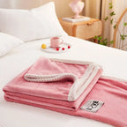 Pink flannel fleece throw blanket folded with white textured border and LOVE logo patch