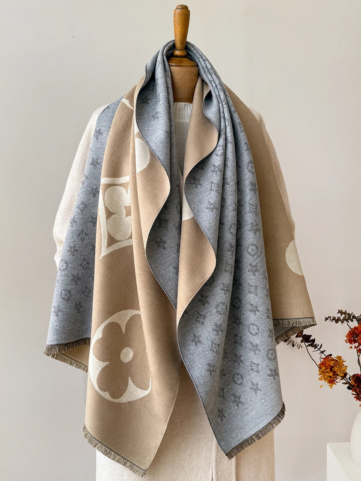 Oversized jacquard scarf in blue-gray, tan, and beige with floral and monogram-style motifs