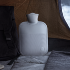 Large hot water bottle with ribbed soft cover, slate blue, wide screw-top, badge