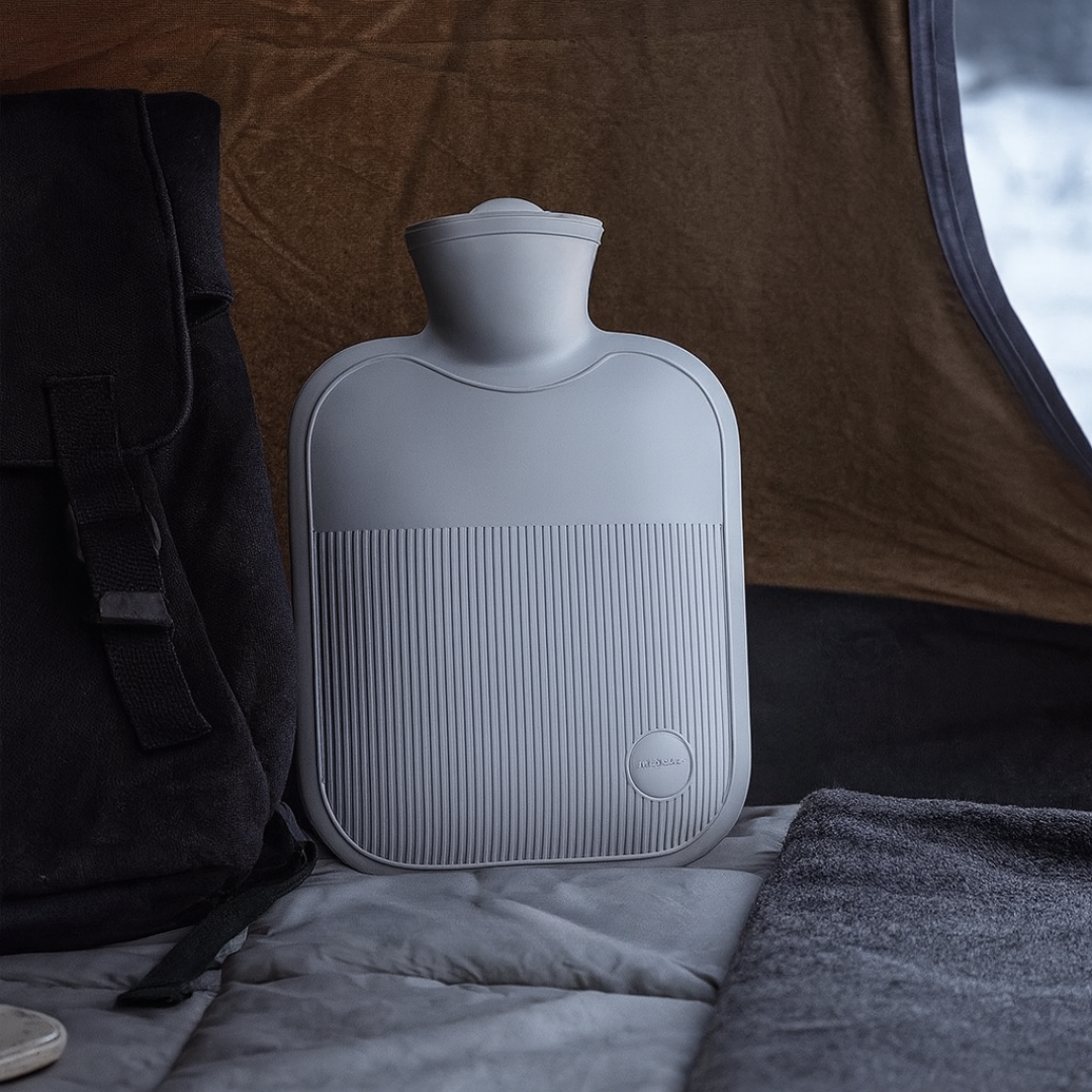 Large hot water bottle with ribbed soft cover, slate blue, wide screw-top, badge