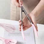 Pink silicone tong with wooden handle for heat-safe cooking and gripping