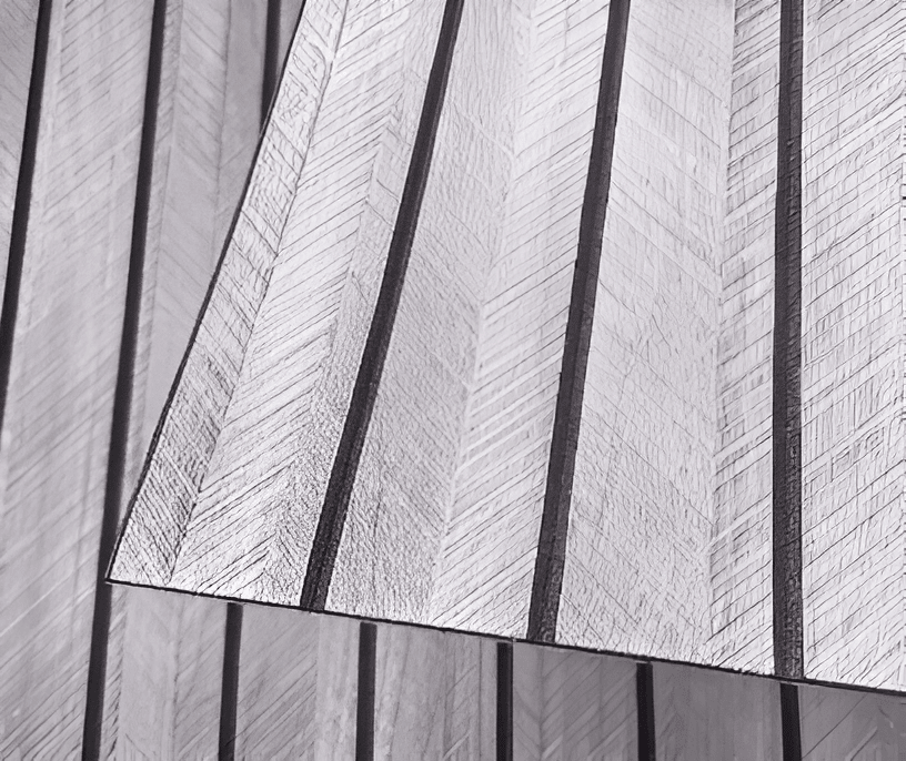White faux wood slat wall panel close-up, raised texture with dark divider lines