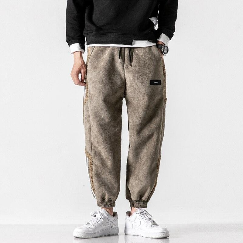 Sherpa-lined brown sweatpants with white side stripes, drawstring waist, and cargo pocket