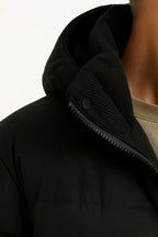 Black hooded puffer jacket with zipper placket and snap tab detail