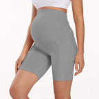 Light gray maternity bike-length leggings with high waist and stitched seam paneling