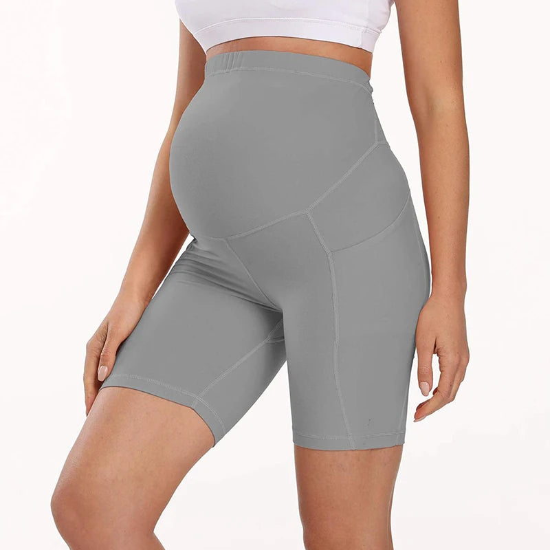 Light gray maternity bike-length leggings with high waist and stitched seam paneling