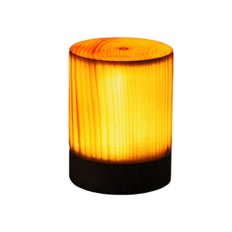 Round cylinder wood-look LED lamp with warm amber glow and textured wood pattern