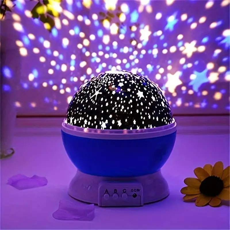 Starry sky night light with black star dome on blue base, purple-lit starry glow