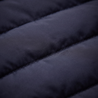 Quilted puffer jacket fabric close-up in dark navy with stitched baffles