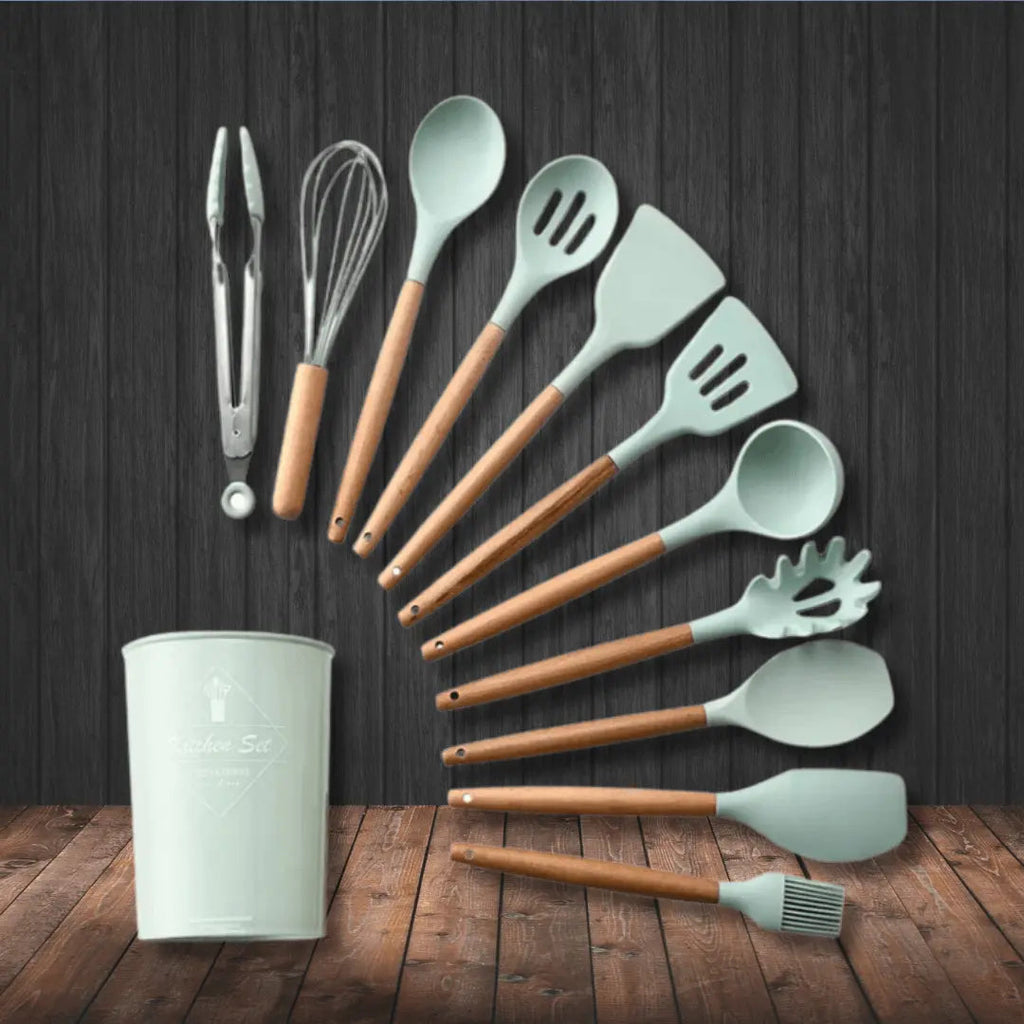 Mint green silicone kitchen utensil set with wooden handles, ladles and spatulas in cup
