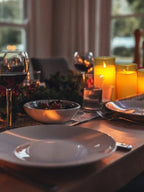 LED flameless candles on a dining table, warm yellow glowing cylinders