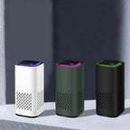 Air purifier set with white, green, and black bodies and LED-lit top panels