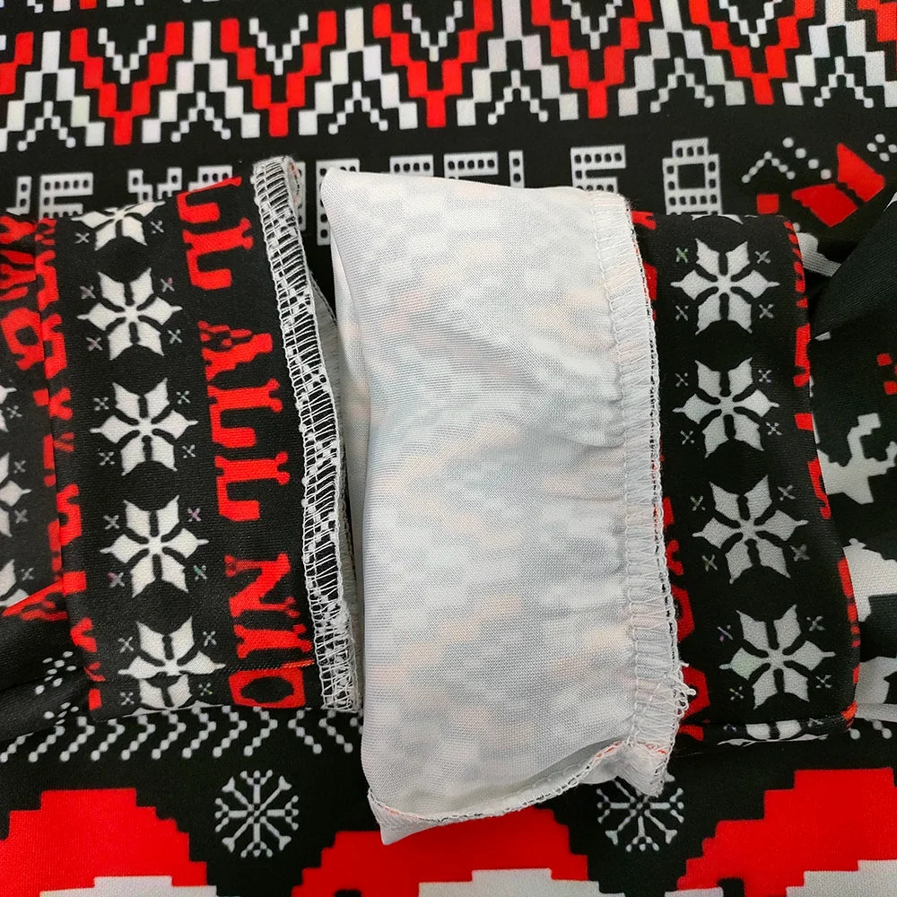 Kissmas sweater inner hem with white label and black/red holiday knit pattern.