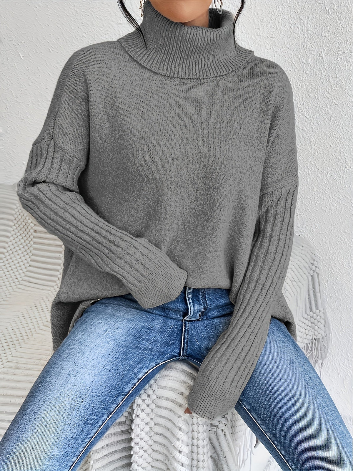 Women’s loose turtleneck sweater, medium gray knit with ribbed cuffs and hem.