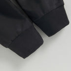 Black knit cuffs on baby stretch pants at pant-leg hem