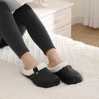 Black slip-on clogs with plush lining, worn with leggings