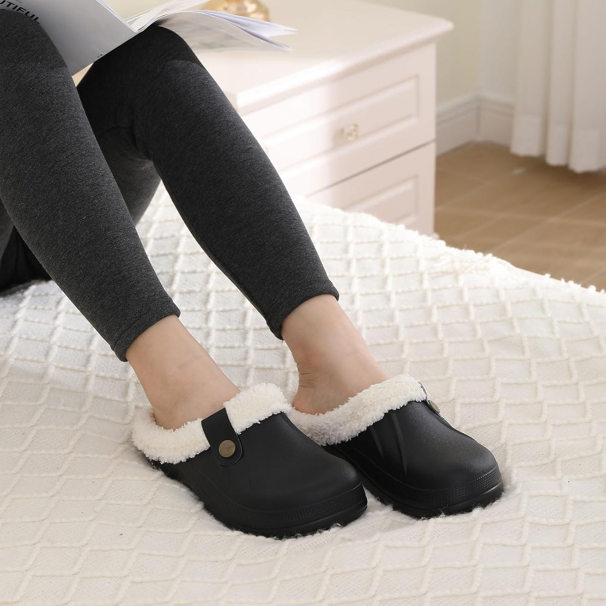 Black slip-on clogs with plush lining, worn with leggings