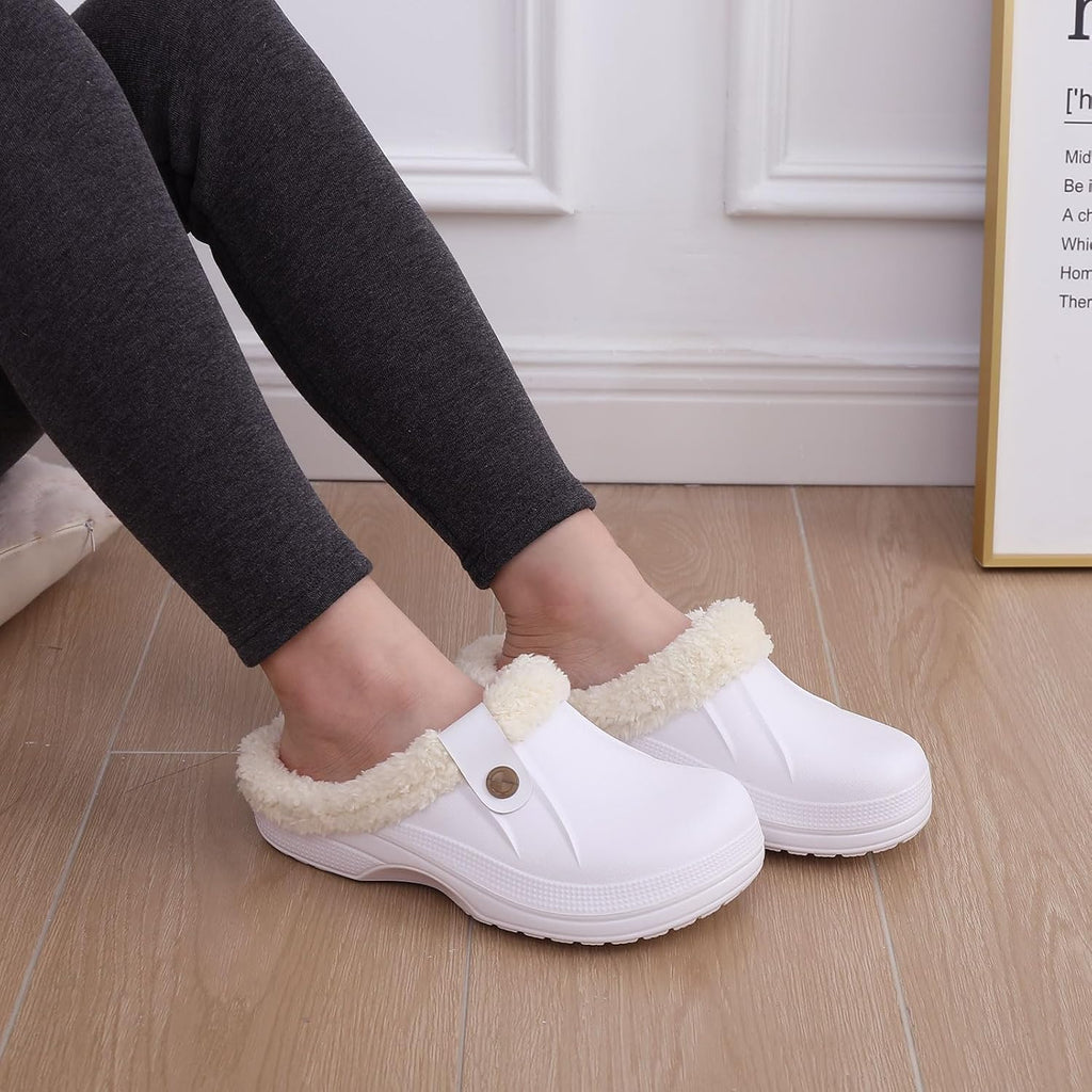 White plush-lined slip-on clogs on a person with bare feet