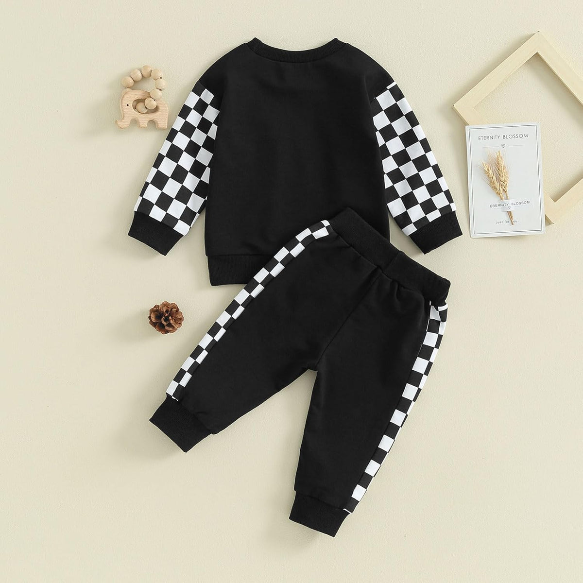 Baby Jogger 2-piece winter outfit: black sweatshirt and sweatpants with white checkered sleeve bands.