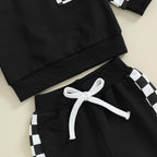 Baby Jogger sweatpants detail: black pants with white check trim and white drawstring tie.