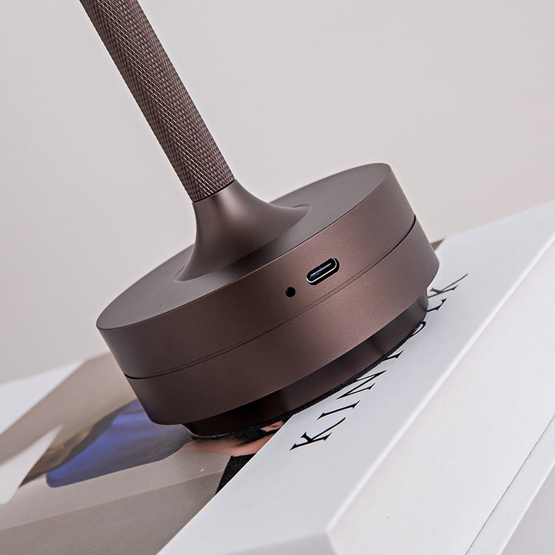Wireless rechargeable table lamp with dark bronze base and charging port on stem