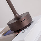 Wireless rechargeable table lamp with dark bronze base and charging port on stem
