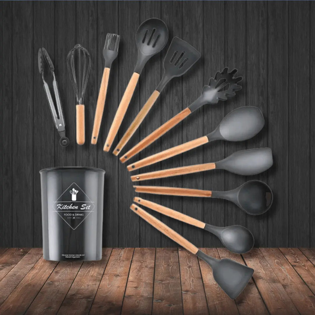 Dark gray silicone kitchen utensil set with wooden handles, ladles and spatulas in cup